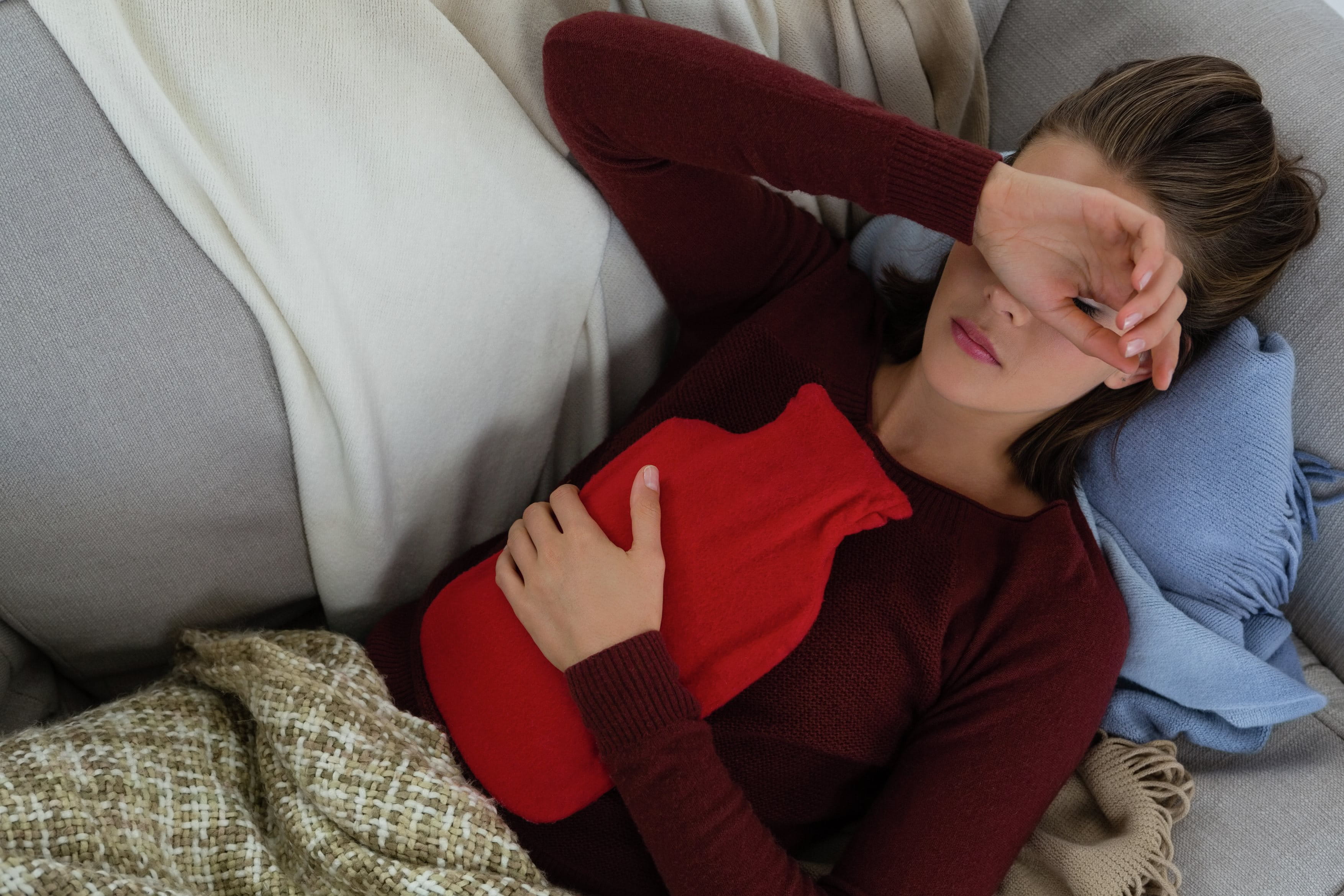 woman holding hot watter bottle