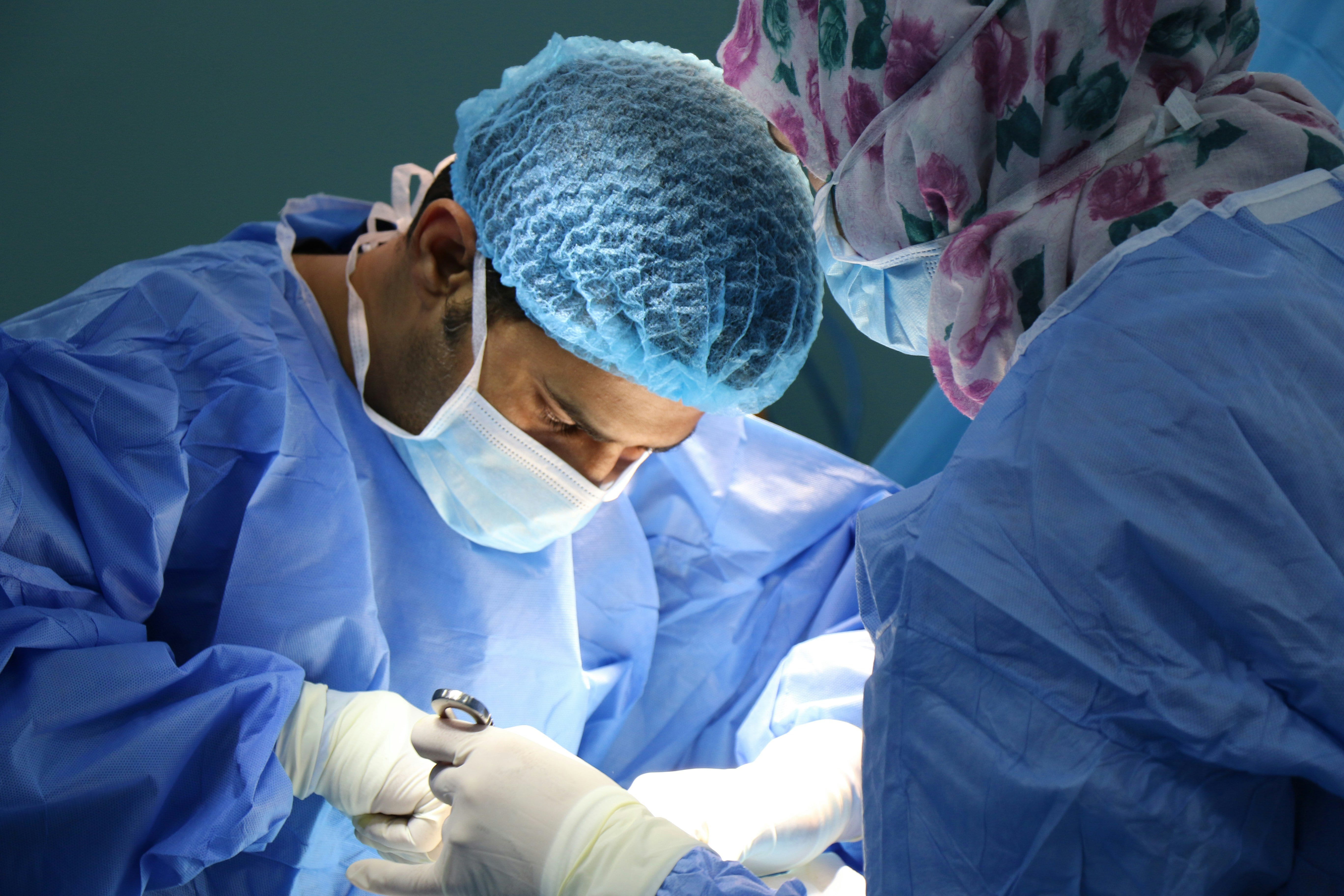 a doctor performing keloid scars removal surgery