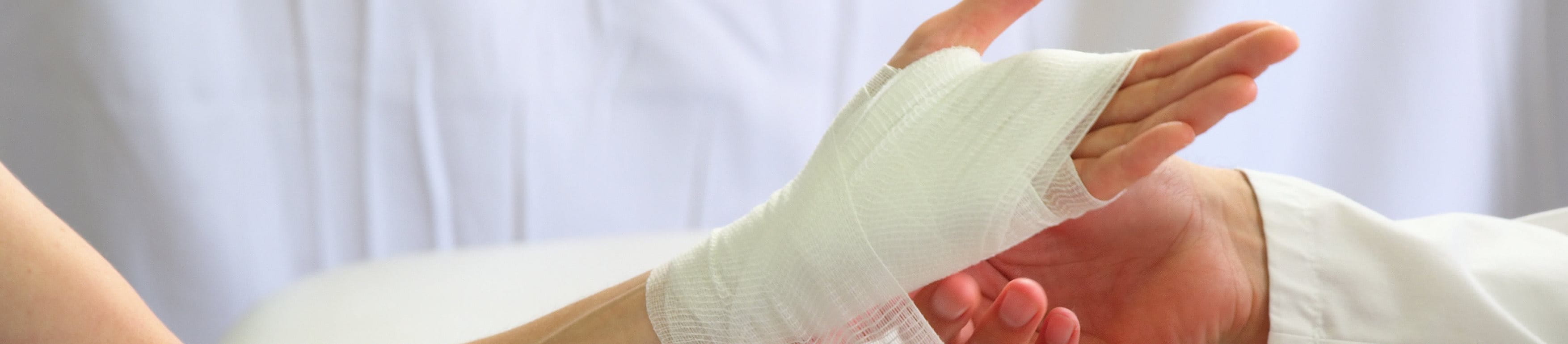 A person using bandage on her hands to stop bleeding