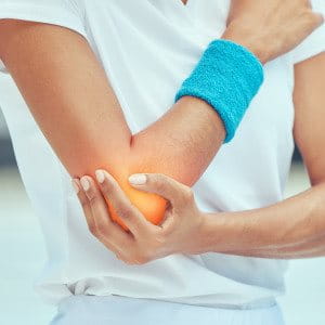 Men lifting up his foot while wearing a bandage