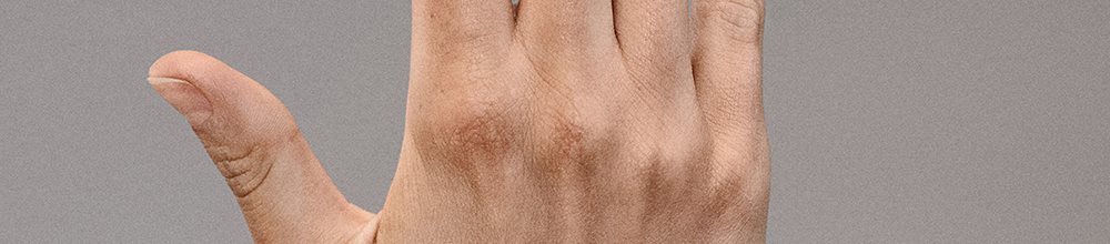 Person applying Elastoplast Second Skin Spray Plaster to their fingertip