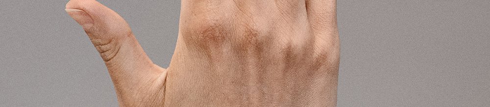 Des mains aux cuticules saines et à la peau hydratée, qui révèlent des doigts soignés.